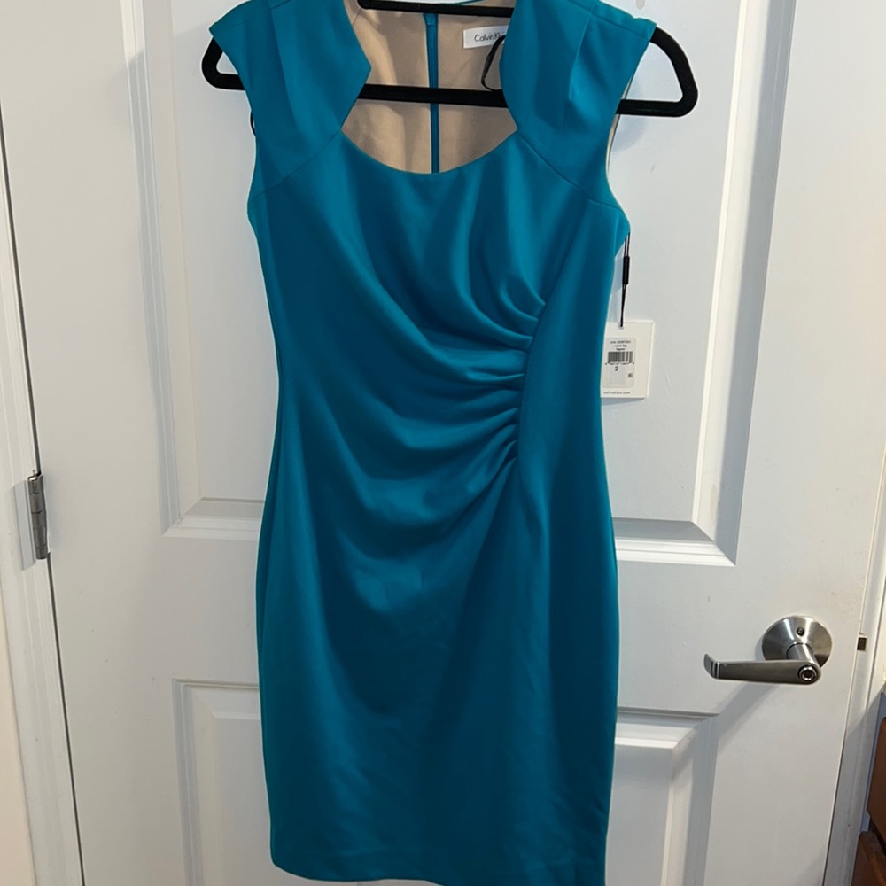 Flawed turquoise dress
